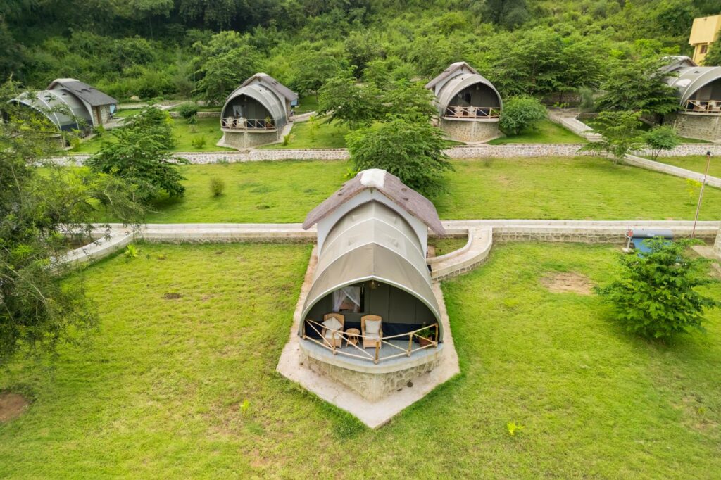 Boutique luxury safari lodge accommodation in Tanzania surrounded by lush natural landscape