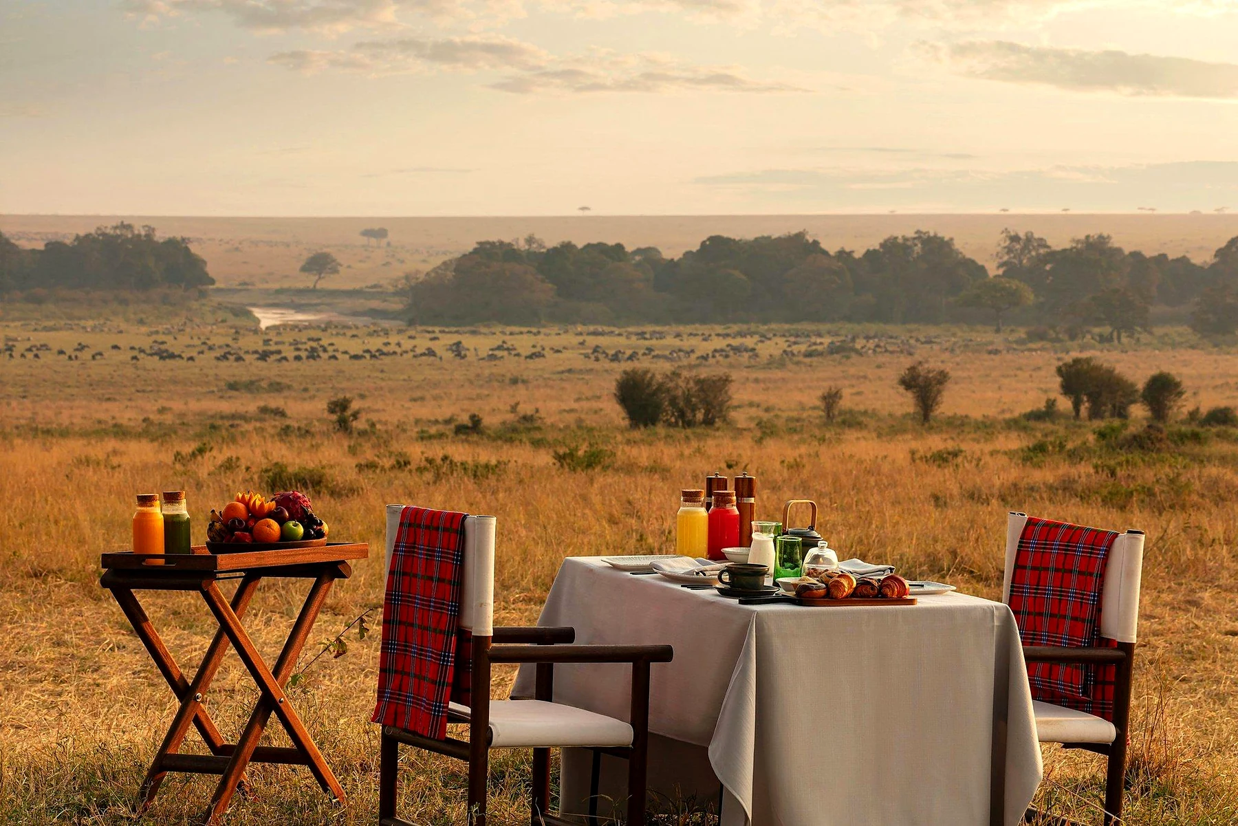 A private breakfast table set on the open plains of the Maasai Mara